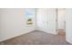 Well-lit bedroom with neutral carpeting, a window, and closet doors at 430 Louisiana Dr, Pittsboro, IN 46167
