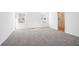 Bright bedroom featuring neutral carpet, natural light from two windows, and an ensuite bath at 430 Louisiana Dr, Pittsboro, IN 46167