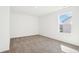 Bright bedroom with a neutral carpet and a large window letting in natural light at 430 Louisiana Dr, Pittsboro, IN 46167