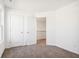 Bright bedroom with neutral carpet, two closets and window letting in natural light at 430 Louisiana Dr, Pittsboro, IN 46167