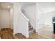 Bright entryway with stairs, white walls, and hard wood flooring leading to the second floor at 430 Louisiana Dr, Pittsboro, IN 46167