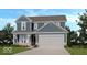 Charming two-story home featuring a light blue exterior, white trim, and attached two-car garage at 430 Louisiana Dr, Pittsboro, IN 46167
