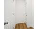 Bright hallway with wood flooring and white walls at 430 Louisiana Dr, Pittsboro, IN 46167