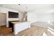 Bright kitchen with dark cabinets, kitchen island, wood floors, and white walls at 430 Louisiana Dr, Pittsboro, IN 46167