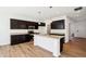 Spacious kitchen with dark cabinets, a center island, and modern appliances at 430 Louisiana Dr, Pittsboro, IN 46167