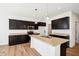 Well-lit kitchen with dark cabinetry, a center island, and recessed lighting for a modern feel at 430 Louisiana Dr, Pittsboro, IN 46167