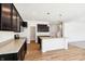 Spacious kitchen with stainless steel appliances, dark cabinets, and wood floor at 430 Louisiana Dr, Pittsboro, IN 46167