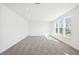 Well-lit living room with neutral carpet and large windows showcasing the neighborhood at 430 Louisiana Dr, Pittsboro, IN 46167