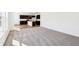 Open living room leading to a kitchen with dark cabinets and an island with modern fixtures at 430 Louisiana Dr, Pittsboro, IN 46167