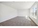 Bright living room with neutral carpet and large windows, offering abundant natural light at 430 Louisiana Dr, Pittsboro, IN 46167