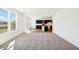 Bright living room open to a kitchen featuring dark cabinets and a dining area with sliding glass doors at 430 Louisiana Dr, Pittsboro, IN 46167