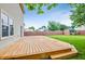 Inviting backyard with a wooden deck and green lawn, perfect for outdoor entertaining and relaxation at 5541 Lippan Way, Indianapolis, IN 46221