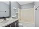 Bathroom featuring a vanity with storage, a tub, and a shower combination with light neutral tones at 5541 Lippan Way, Indianapolis, IN 46221