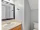 Powder room featuring a clean vanity, mirror, and toilet, offering convenience for guests at 5541 Lippan Way, Indianapolis, IN 46221