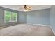 Spacious bedroom with neutral carpet, natural light, and a ceiling fan; comfortable and functional for relaxation at 5541 Lippan Way, Indianapolis, IN 46221