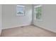Bright bedroom with neutral carpet, natural light from two windows, and a comfortable, inviting feel at 5541 Lippan Way, Indianapolis, IN 46221