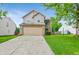 Traditional two-story home with a brick-accented garage, green lawn and driveway at 5541 Lippan Way, Indianapolis, IN 46221