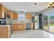 Bright kitchen featuring stainless steel appliances, light-colored cabinets, and a tile backsplash at 5541 Lippan Way, Indianapolis, IN 46221
