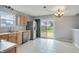 Sunny kitchen features tile flooring, stainless steel appliances, and sliding glass door to the deck at 5541 Lippan Way, Indianapolis, IN 46221