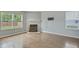 Bright living room with large windows, fireplace, wall mounted TV, and hardwood flooring at 5541 Lippan Way, Indianapolis, IN 46221