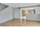 Open concept living room with hardwood floors seamlessly connects to the kitchen and dining area at 5541 Lippan Way, Indianapolis, IN 46221