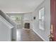 Sunlit living room with hardwood floors, a fireplace, and an open staircase at 5541 Lippan Way, Indianapolis, IN 46221