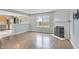 Bright living room featuring hardwood flooring, fireplace, and an abundance of natural light at 5541 Lippan Way, Indianapolis, IN 46221