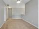 Neutral carpeted loft with ceiling fan and multiple doorways; ideal for flexible use and easy access at 5541 Lippan Way, Indianapolis, IN 46221