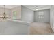 Neutral, carpeted loft with fan, chandelier, and natural light from windows, great for flexible living space at 5541 Lippan Way, Indianapolis, IN 46221