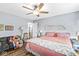 Bedroom featuring hardwood floors, a ceiling fan, and a sofa at 5865 Pennekamp Dr, Plainfield, IN 46168