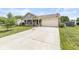 Well-maintained single-story home with a spacious driveway and manicured lawn at 5865 Pennekamp Dr, Plainfield, IN 46168