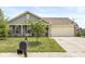 Charming single-Gathering home with a well-manicured lawn and attached two-car garage at 5865 Pennekamp Dr, Plainfield, IN 46168