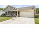 Inviting single-Gathering home featuring a covered porch, two car garage, and lovely landscaping at 5865 Pennekamp Dr, Plainfield, IN 46168