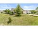 Landscaped front yard featuring green lawn, flowering shrubs and mature trees at 5865 Pennekamp Dr, Plainfield, IN 46168