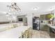Kitchen featuring modern appliances, stylish lighting, and an open layout connecting to the living area at 5865 Pennekamp Dr, Plainfield, IN 46168