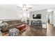 Comfortable living room with hardwood floors, a ceiling fan, and a decorative fireplace at 5865 Pennekamp Dr, Plainfield, IN 46168