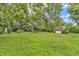 A large backyard with mature trees and a shed at 6349 S Harding St, Indianapolis, IN 46217