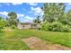 View of the back of the house with yard, landscaping and a small back porch at 6349 S Harding St, Indianapolis, IN 46217