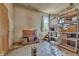Unfinished basement with exposed walls, rudimentary fireplace, and storage racks at 6349 S Harding St, Indianapolis, IN 46217