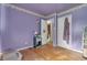 Bedroom featuring hardwood floors, floral wallpaper and neutral tones at 6349 S Harding St, Indianapolis, IN 46217