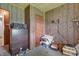 Bedroom featuring wood paneling, dresser, and minimal natural light at 6349 S Harding St, Indianapolis, IN 46217