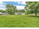 A single-story home with a well-manicured lawn, and mature trees at 6349 S Harding St, Indianapolis, IN 46217