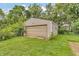 A detached garage with a large roll up door at 6349 S Harding St, Indianapolis, IN 46217