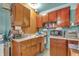 Functional kitchen with vintage wood cabinets, offering ample storage space at 6349 S Harding St, Indianapolis, IN 46217