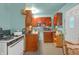 Efficient kitchen space with white appliances and wooden cabinets at 6349 S Harding St, Indianapolis, IN 46217