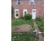 Home exterior with brick facade and overgrown front yard needing some love at 8256 Meadowlark Dr, Indianapolis, IN 46226