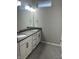 Bathroom features a double vanity with granite countertop, and a tiled floor at 9215 Hawley Dr, Indianapolis, IN 46216