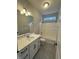 Bright bathroom featuring a shower-tub combination, with a white vanity and a modern sink at 9215 Hawley Dr, Indianapolis, IN 46216