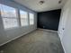 A carpeted bedroom boasts natural light and modern accents, blending style and comfort for a peaceful retreat at 9215 Hawley Dr, Indianapolis, IN 46216