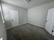 A carpeted bedroom offers a cozy space with neutral paint and ample natural light from a window, ready for personalization at 9215 Hawley Dr, Indianapolis, IN 46216